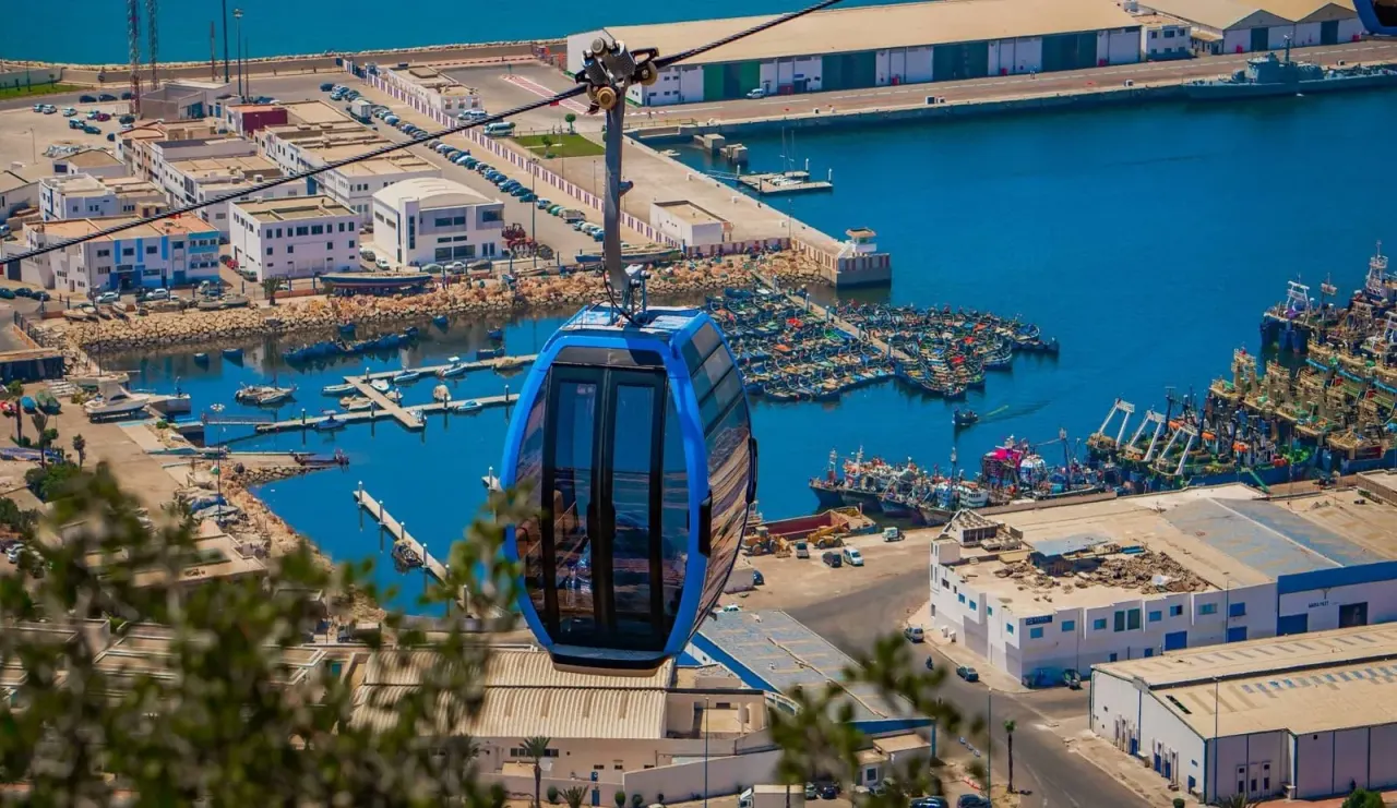 Agadir cable car cabin gliding above the marina and the Atlantic coast