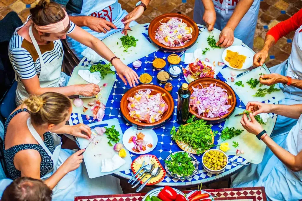Moroccan cooking class table with fresh vegetables, herbs and tagine ingredients in Agadir