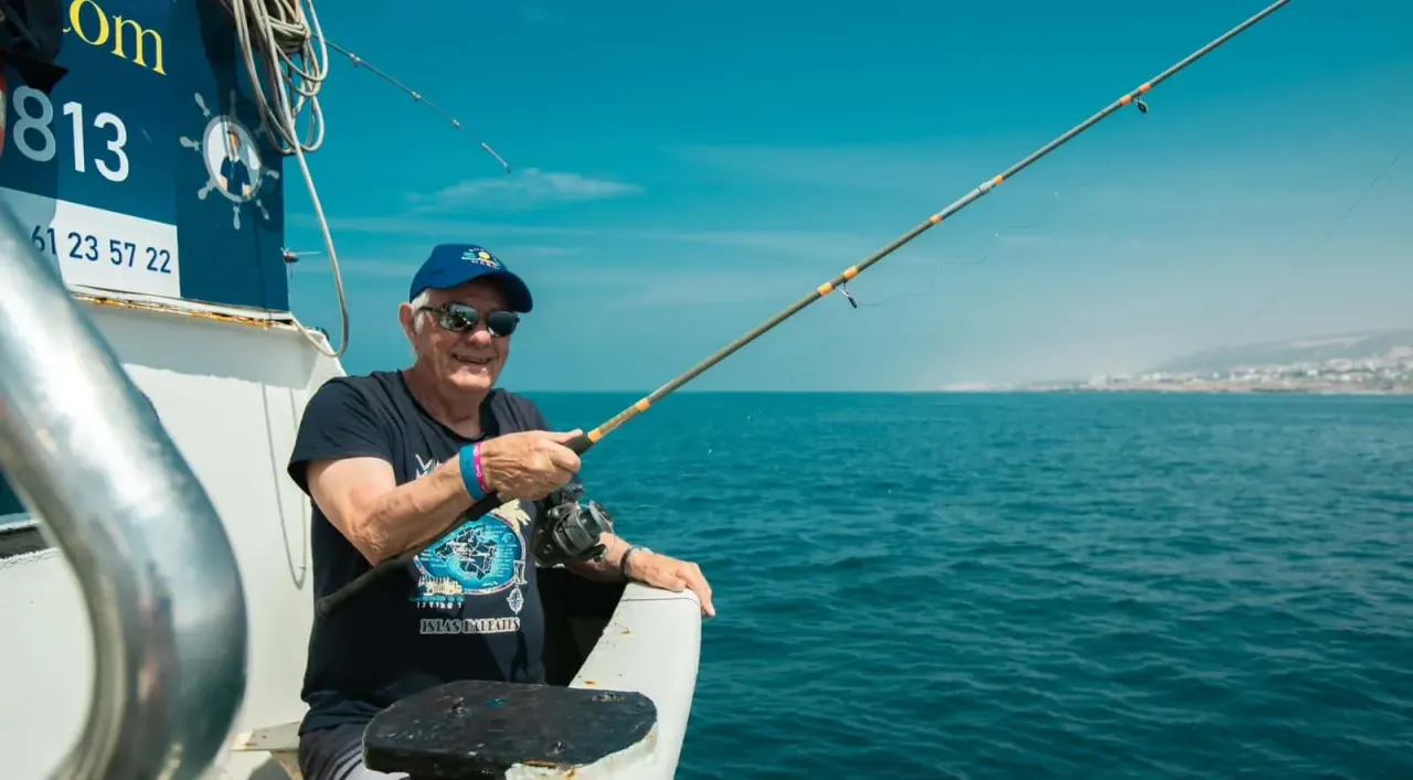 Angler fishing from a boat on the Atlantic off Agadir Marina, Morocco