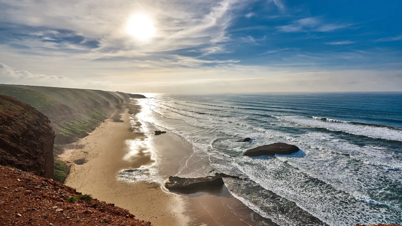 Atlantic beach and red rock cliffs at Legzira on Morocco's southern coast