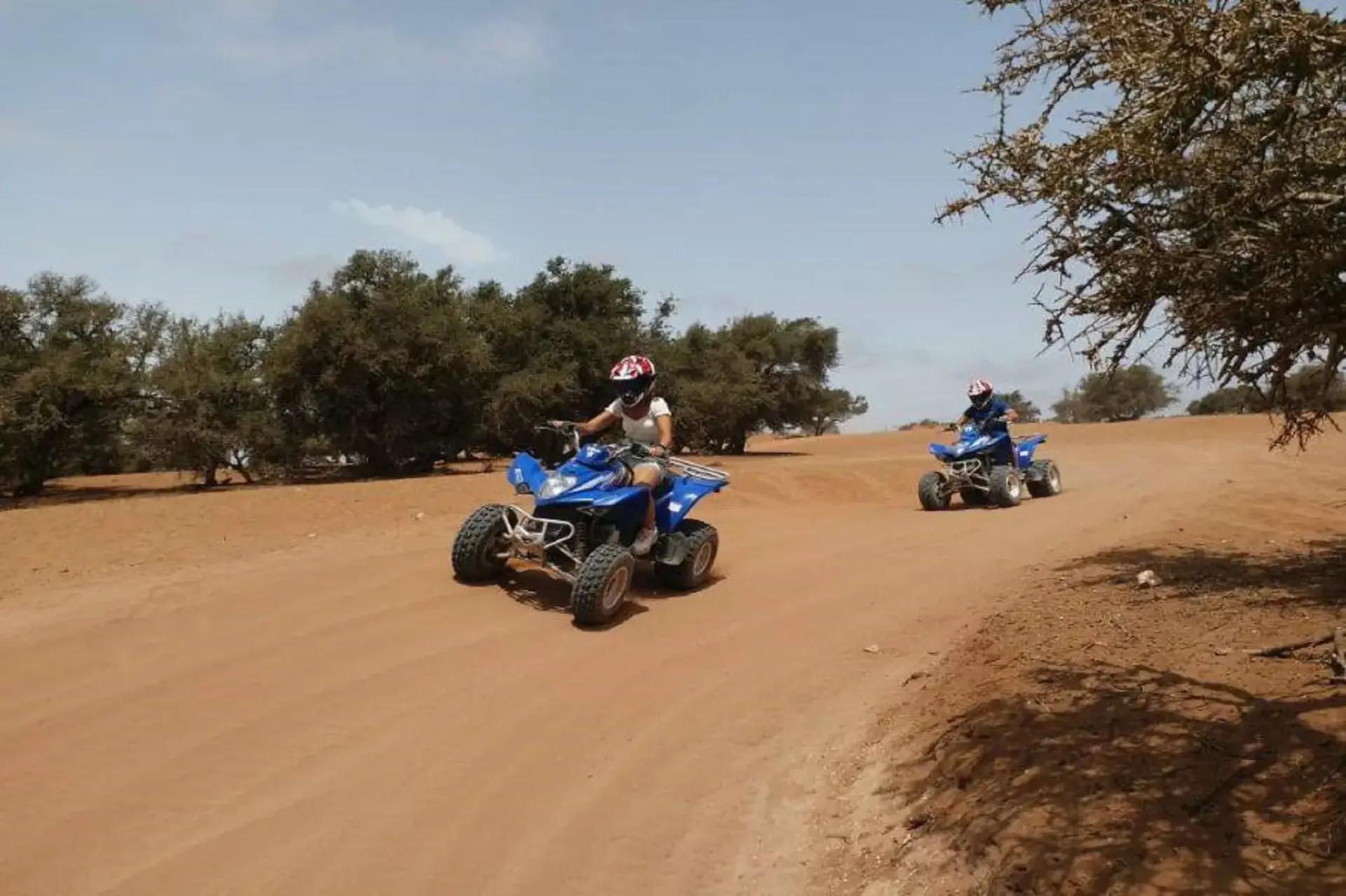 Two quad bikes ridden along a sandy track through the argan forest near Agadir