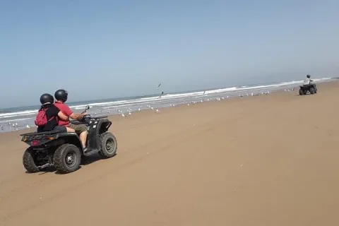 Quad bike on the coastal dune tracks with the Atlantic behind