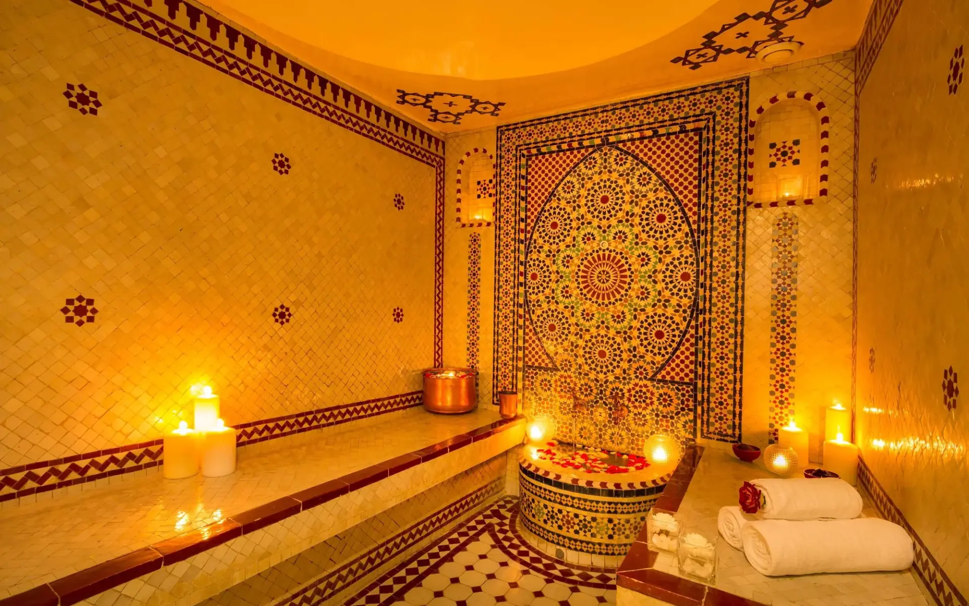Traditional Moroccan hammam with mosaic tiling and candlelight in Agadir